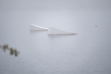 Wakeboarding Ramp on Calm Water in Winter Fog