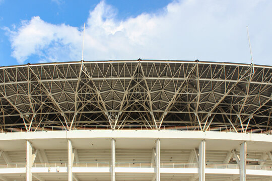 Straight-on central view of the massive steel structure roof detail of the Gelora Bung Karno Main Stadium, creating a repeating geometric texture.