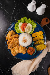 Delicious Indonesian Fried Chicken with Rice and Vegetables.