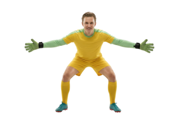 Focused male soccer goalkeeper in yellow uniform and green gloves ready to block a shot on white background.