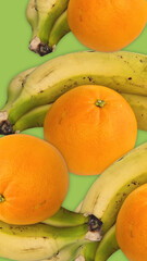 Fresh bananas and oranges forming a vibrant pattern on a bright green backdrop