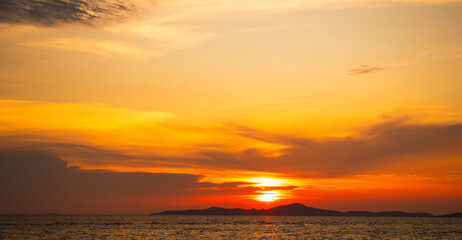 Fototapeta premium Sea sunset sky evening sunrise cloud weather dramatic landscape goldent and indigo color gradient pastel horizon, twilight yellow golden reflection morning nature environment energy ecosystem change.