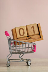 June 1, concept of sale. wooden calendar made of blocks in a metal shopping basket