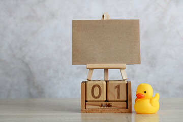 June 1st, Children's Day concept. wooden calendar, rubber duckling and an empty card for text.