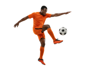Soccer player in orange uniform kicking ball isolated on white background