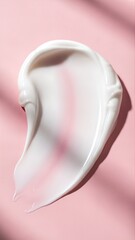 White cream smear on pink background cosmetic product texture.