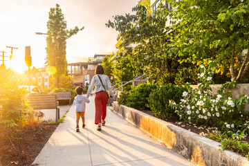 Mother and son walking at sunset in vancouver, british columbia