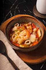 Delicious Seafood Soup with Shrimp and Calamari in a Rustic Bowl.