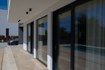 Modern luxury villa with swimming pool and clean minimalist architecture under a blue sky....