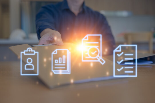 Close-up of a businessperson's hand reaching for a confidential folder on an office desk, symbolizing urgency, data handling, document management, and business communication in the workplace