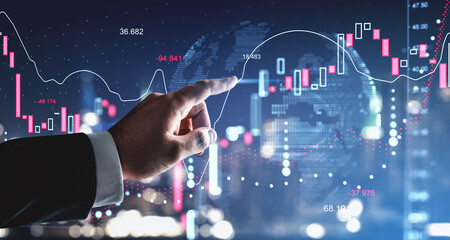 Businessman pointing at glowing digital forex stock chart with candle bars and data lines on futuristic background showing market analysis concept..