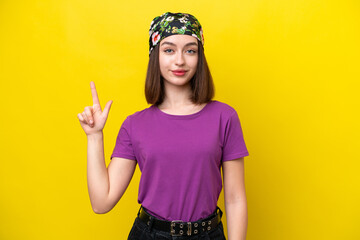 Young Ukrainian woman isolated on yellow background pointing up a great idea