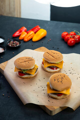Three mini cheeseburger sliders with fresh ingredients