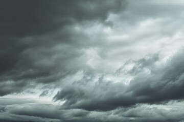 Clouds gather and darken the sky, signaling rain in the late afternoon near the mountains