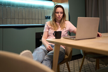 Woman concerned about online privacy while working on laptop