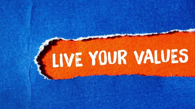 Live your values message writing on ripped torn paper background