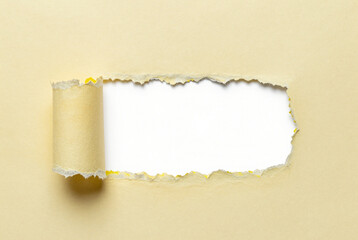 Torn piece of paper on a beige background.