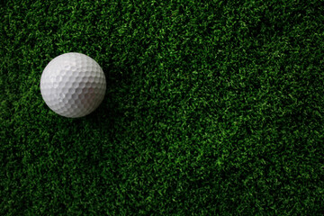 White Golf Ball on Artificial Turf Background with Green Texture