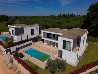 Aerial view of two stunning modern luxury villas with private swimming pools, elegant architecture,...