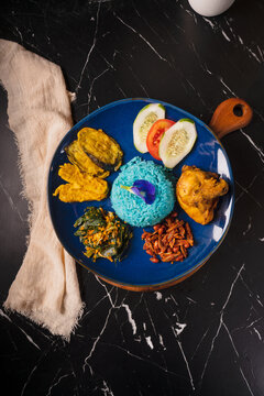 Traditional Malaysian Nasi Kerabu with Fried Chicken and Vegetables.