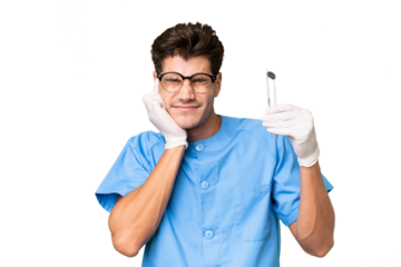 Young dentist man holding tools over isolated background frustrated and covering ears