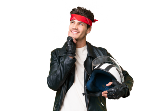 Young caucasian man with a motorcycle helmet over isolated background thinking an idea while looking up - Powered by Adobe