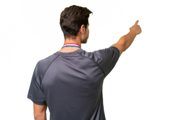 Young caucasian man with medals over isolated background pointing back with the index finger