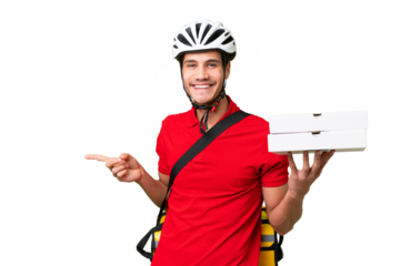 Pizza delivery man with work uniform picking up pizza boxes over isolated background pointing finger to the side