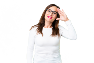 Middle age woman over isolated chroma key background saluting with hand with happy expression