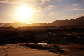 Sunset on the Joaquina dunes, white sand dunes on the island of Florianopolis, Santa Catarina, Brazil.