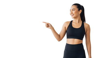 Young woman in sportswear pointing to the side with a smile