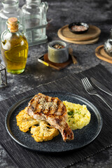 Grilled pork chop with mashed potatoes and cauliflower