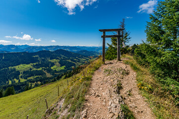Tranquil alpine path reveals breathtaking highland vistas under golden sunlight