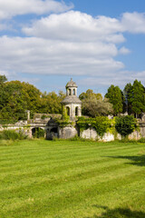 Stone folly structure standing in green field Combiers France