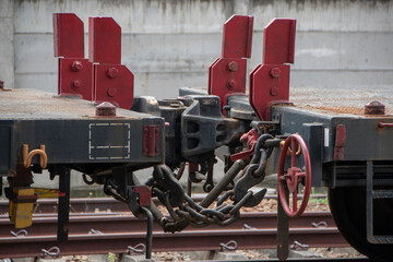 Photograph, side view of empty freight train wagons parked on station railway tracks.