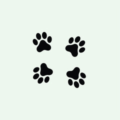 Four black stylized animal paw prints, arranged in a grid, stand out against a soft, pale green background, suggesting a cute pet theme.