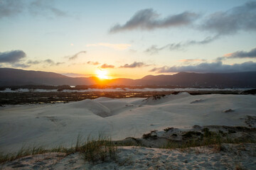 Sunset on the Joaquina dunes, white sand dunes on the island of Florianopolis, Santa Catarina, Brazil.