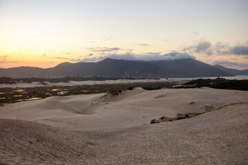Sunset on the Joaquina dunes, white sand dunes on the island of Florianopolis, Santa Catarina, Brazil.