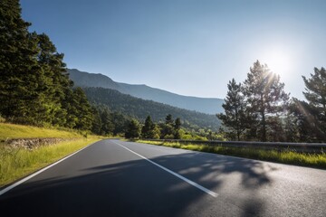 A winding road cuts through rolling green hills as vehicle light trails suggest motion