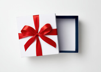 A gift box with a ribbon sits open on a light surface