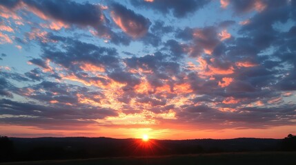 Sunset casting fiery orange and pink hues over a landscape