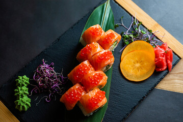 Fresh Salmon Sushi Rolls on Slate Board © Aliaksandr