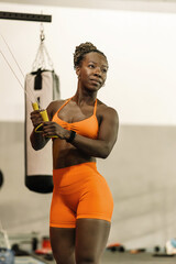 Happy black woman training strength and endurance at the gym.