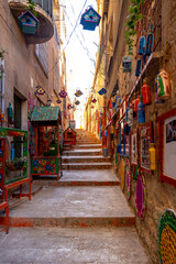 Fototapeta premium Mardin’s Medieval Old Town. Limestone buildings cascade down the rocky hill, tumbling to the Mesopotamian Plain far below. Between these heritage homes, a labyrinth of tight cobblestone lanes wind up 