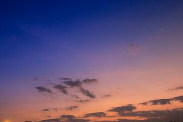 Beautiful golden sunset light paints the clouds and sky with vibrant orange and red hues in the evening nature landscape