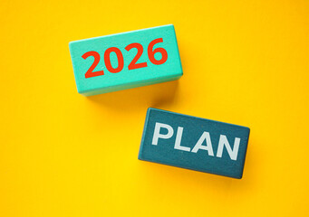 Plan 2026 Text on Wooden Blocks on a Yellow Background. New Start, Vision, Resolution, Goal, and happy New Year concept. 