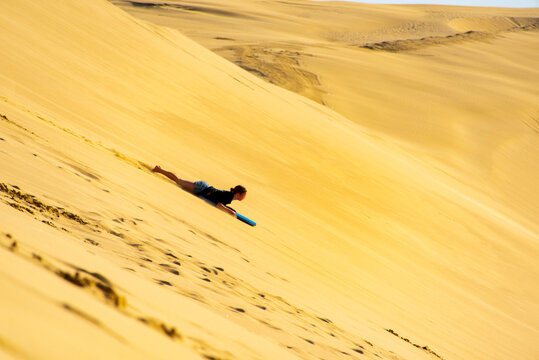 Sandboarding at the Giant Sand Dunes in Cape Reinga - New Zealand