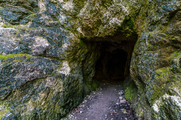 Mysterious slovenian waterfall hidden within rugged natural cave entrance