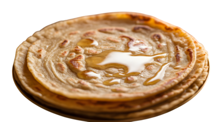Stack of flaky paratha bread drizzled with golden honey or ghee on transparent background