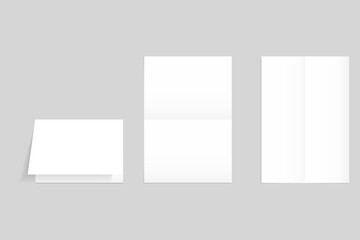 A set of folded sheets of paper isolated on a gray background. Clean white pages with fold lines, an empty background for an old document, letter or leaflet, and a worn poster layout. 